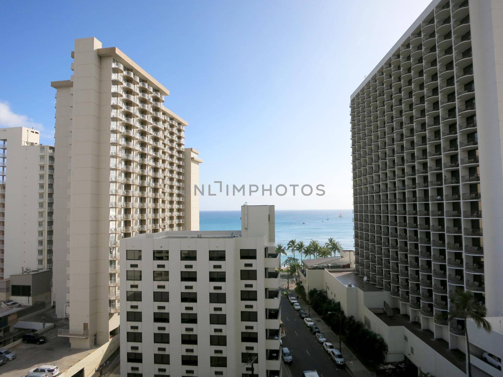 Waikiki - April 24, 2016: Waikiki Hotels, street and Ocean during day.                     