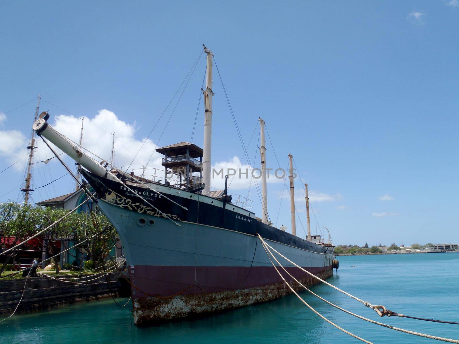 Historic Falls of Clyde Ship sits in Honolulu Harbor. Falls of Clyde is the last surviving iron-hulled, four-masted full rigged ship, and the only remaining sail-driven oil tanker. Designated a U.S. National Historic Landmark in 1989