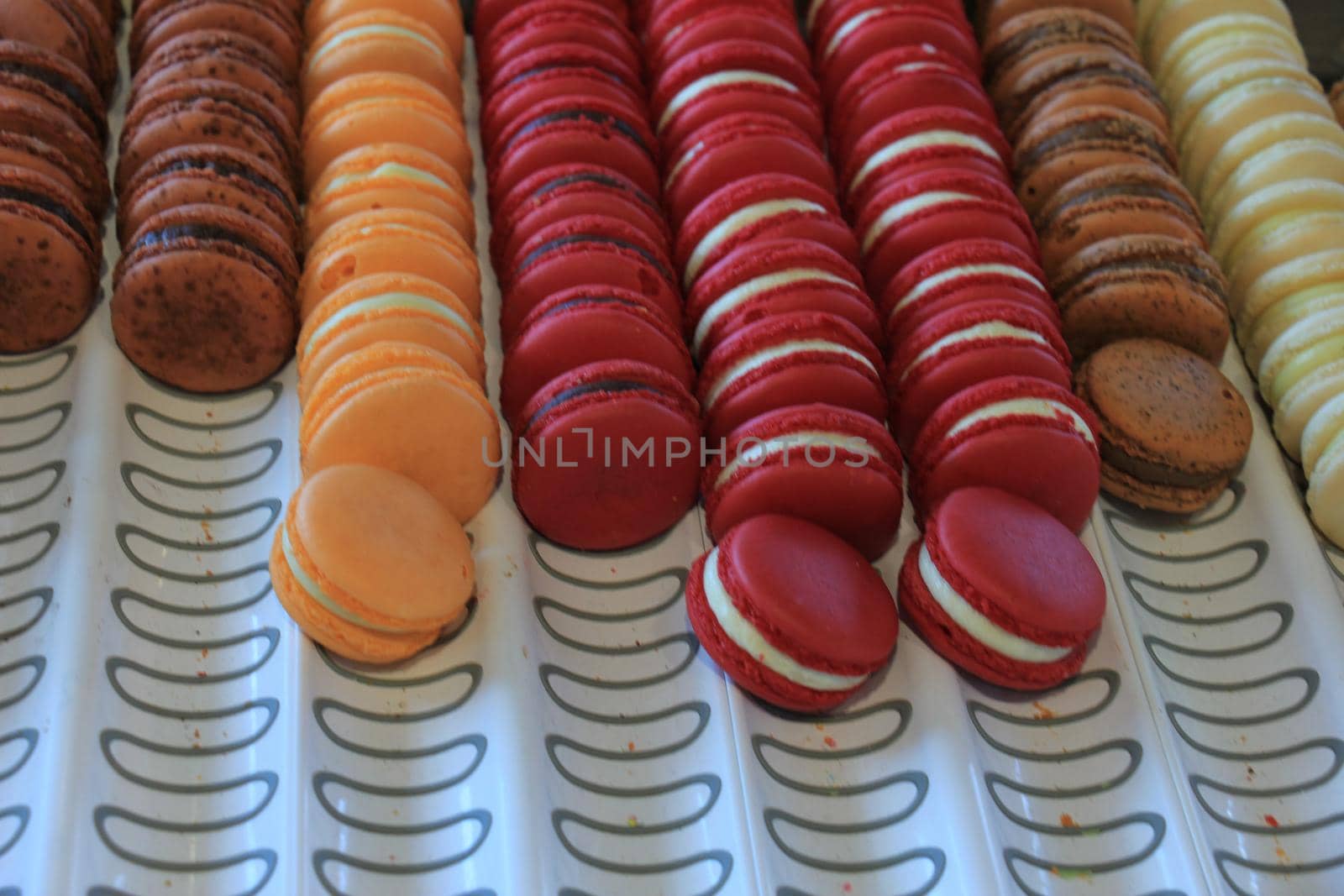 Macarons in various flavors and colors on display in a store