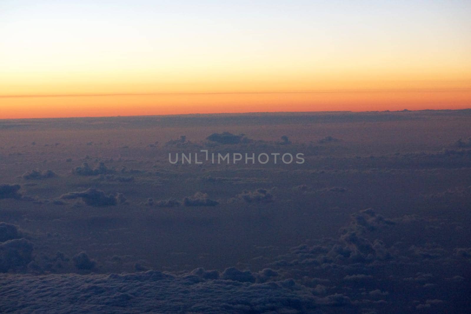 Aerial of Sunrise light over the world full of clouds over the pacific ocean.