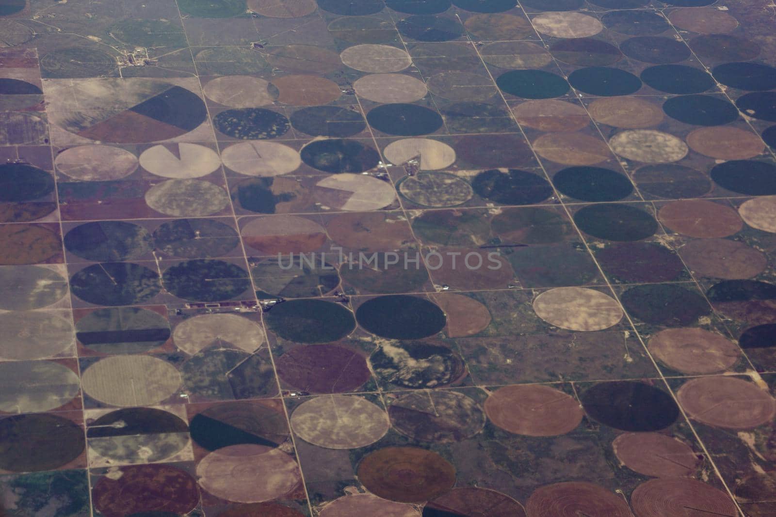 High aerial view of the crop circles created in farm fields by center pivot sprinklers by EricGBVD