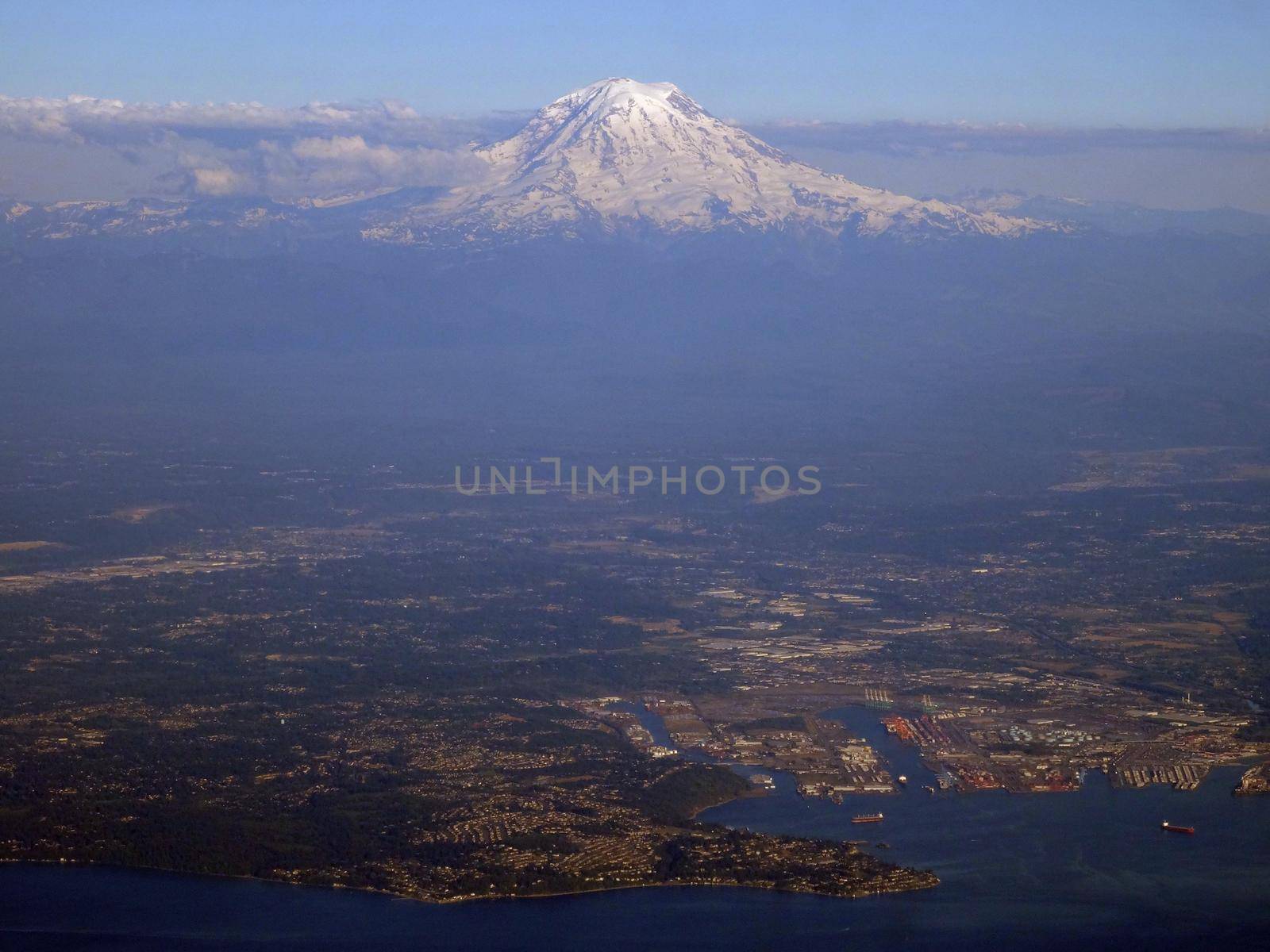 Aerial view Tacoma Harbor and City with coast and Mount Rainier visible in the distance on June 26, 2016 in Seattle, WA.