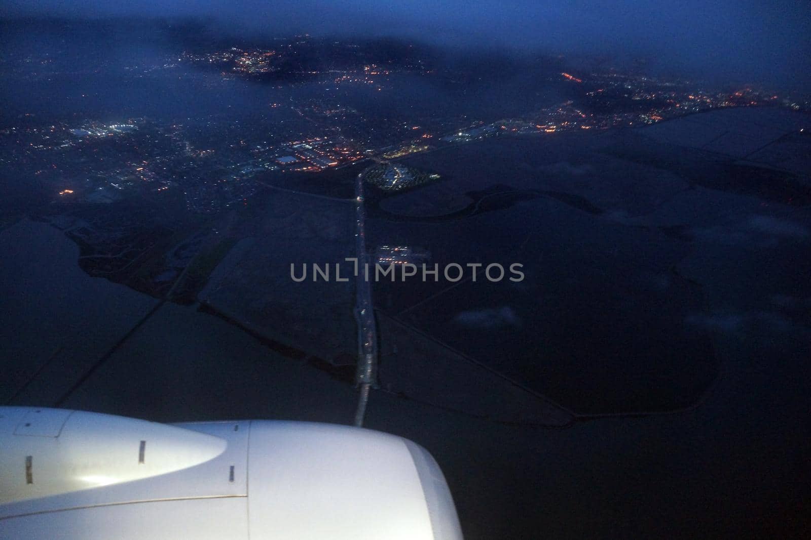 Aerial view Plane jet, salt evaporation ponds, bridge, and cities surrounding San Francisco Bay at dawn by EricGBVD