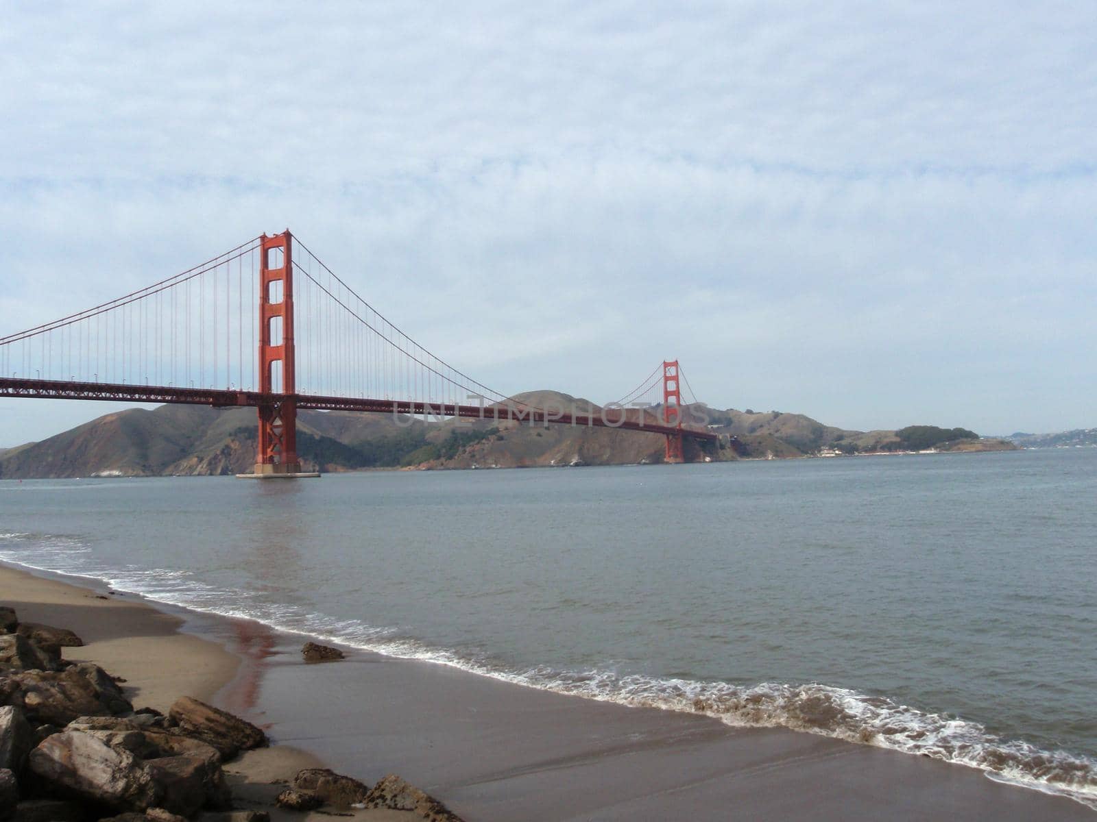 Beach and Golden Gate Bridge in the distance by EricGBVD