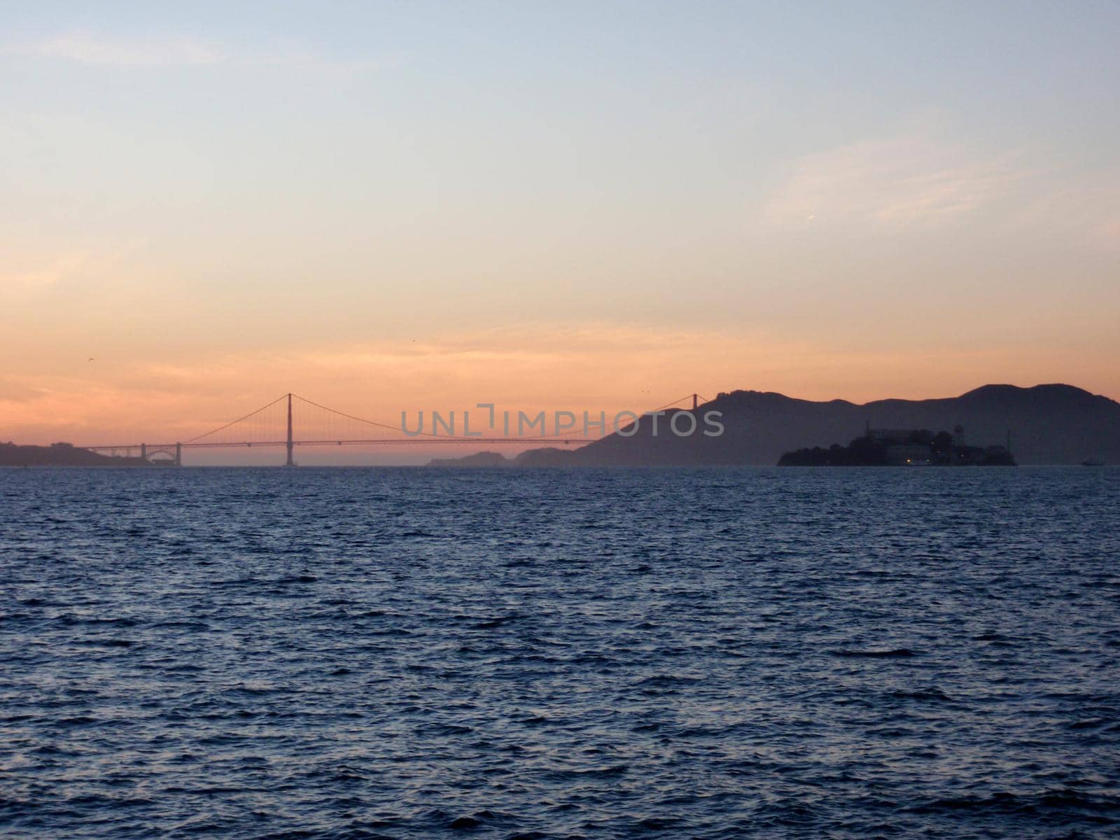 San Francisco city skyline, Golden Gate Bridge, and Alcatraz Island at dusk by EricGBVD