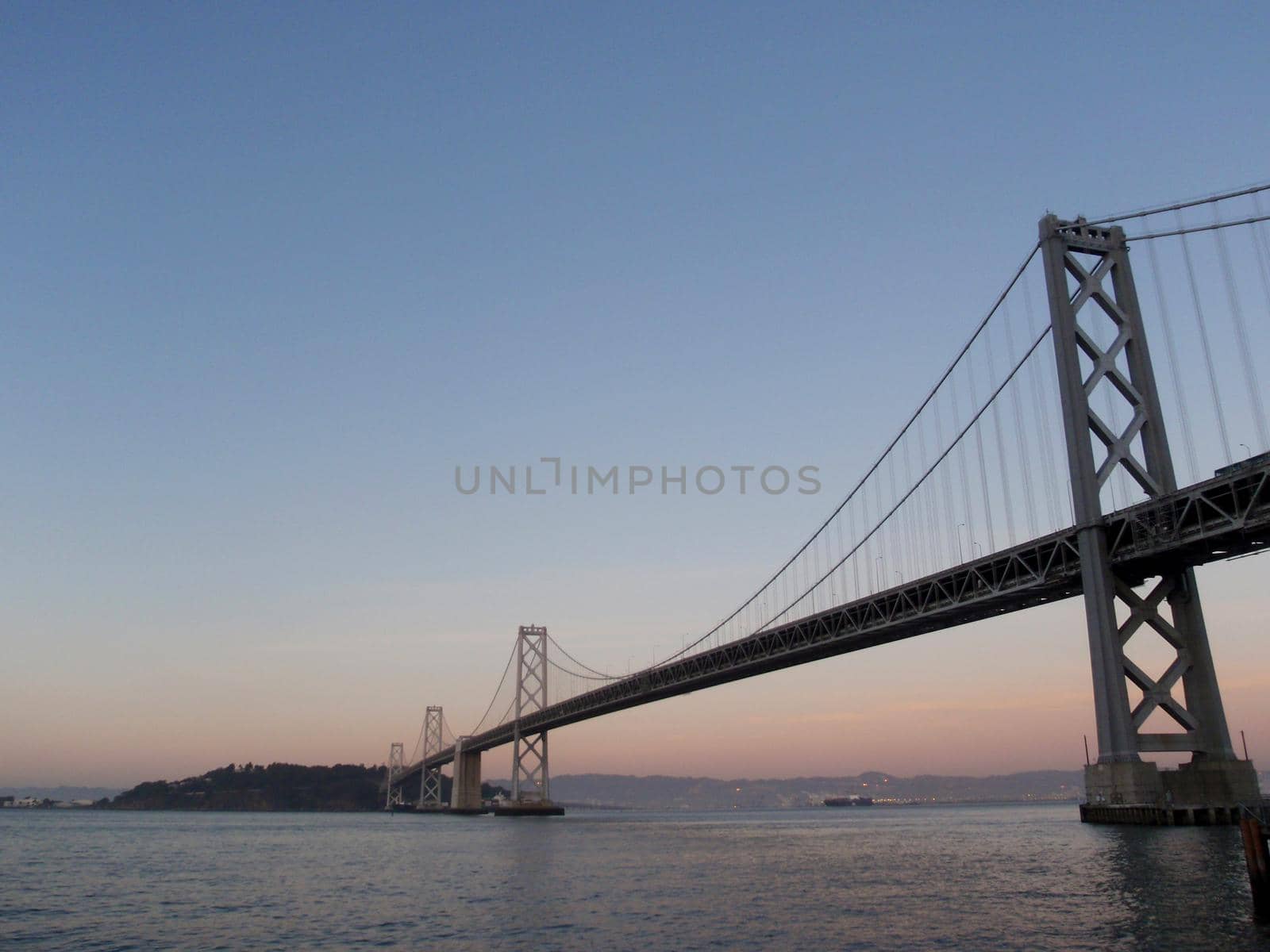 San Francisco side of Bay Bridge at dusk by EricGBVD