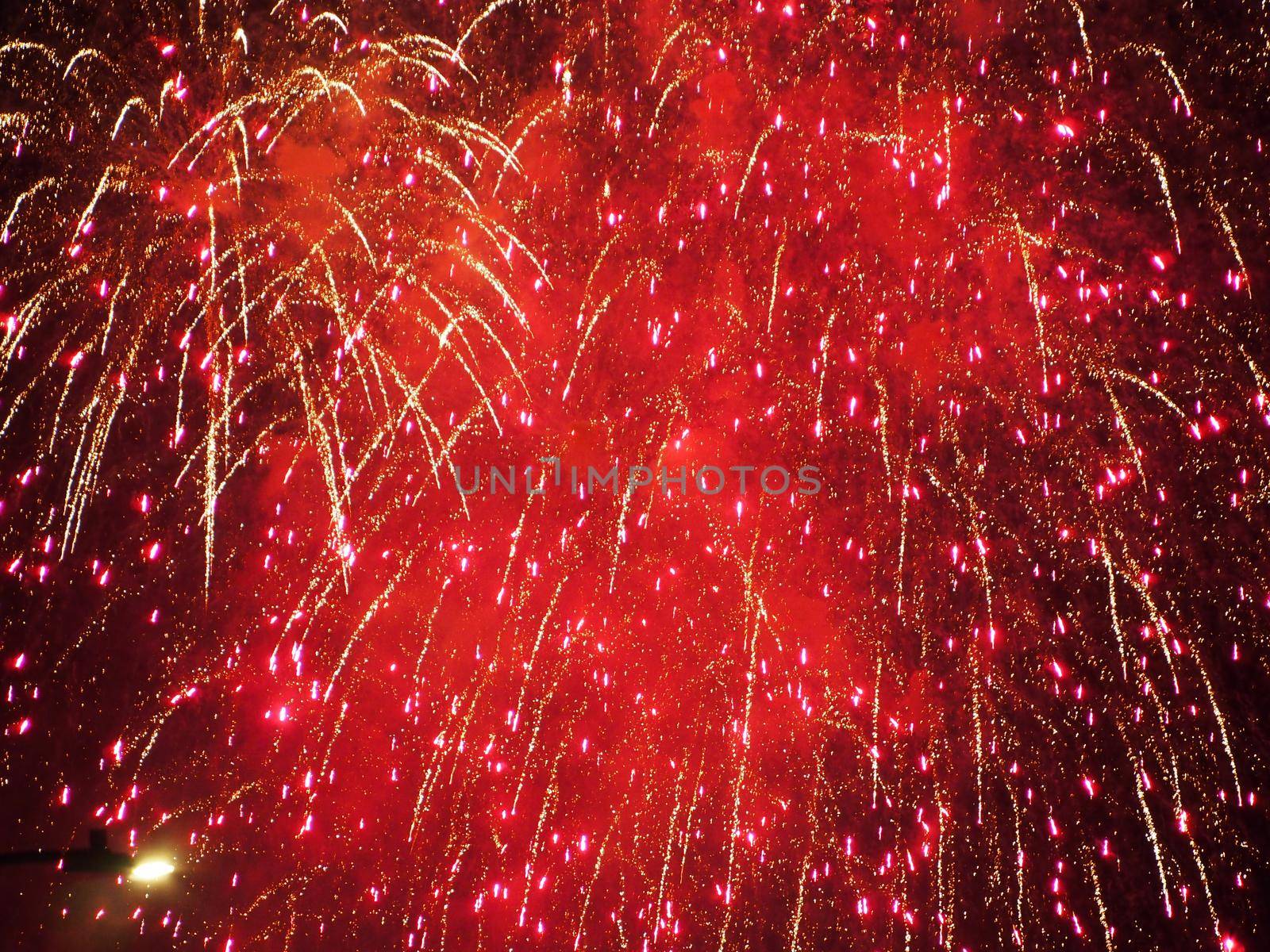 Honolulu - June 4, 2019: Friday night Fireworks with red color burst in the air above Waikiki, Hawaii.