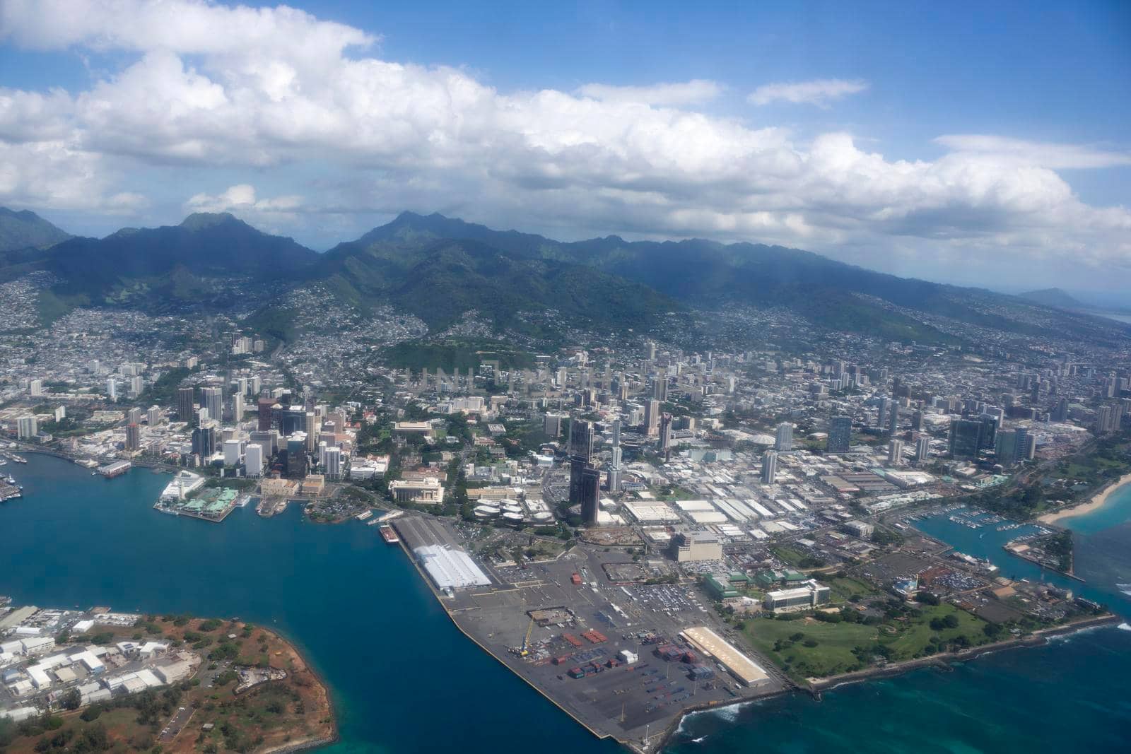 Honolulu - November 10, 2014:  Aerial of Honolulu Cityscape including Harbor, Downtown, Kewalo Basin, Aloha Tower, Pier 1, Re-Use Hawaii, Medical College, and Water Treatment Plant along the coast at the harbor entrance of Oahu, Hawaii.