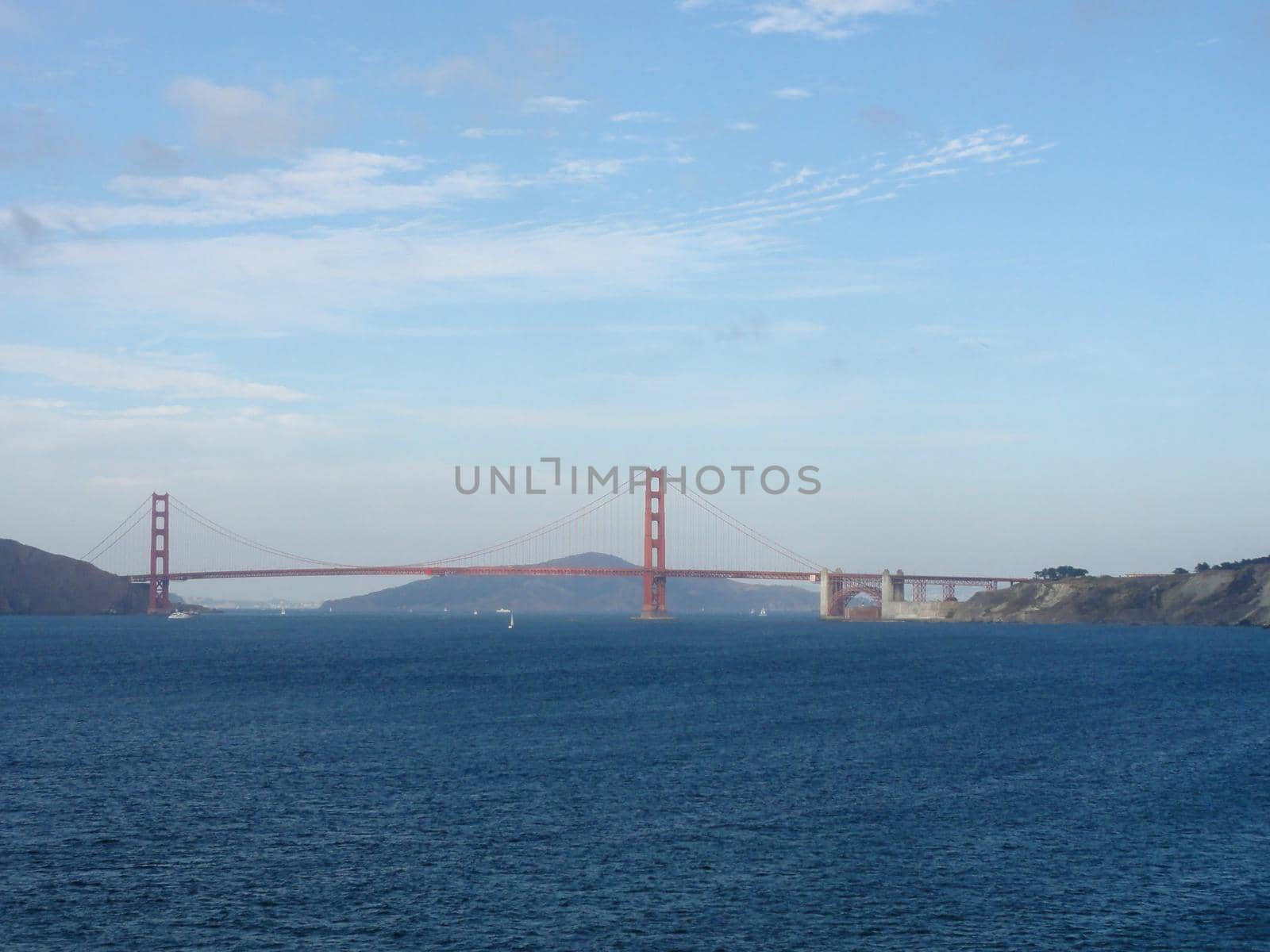 Golden Gate Bridge with sail boats in the bay in San Francisco, California.