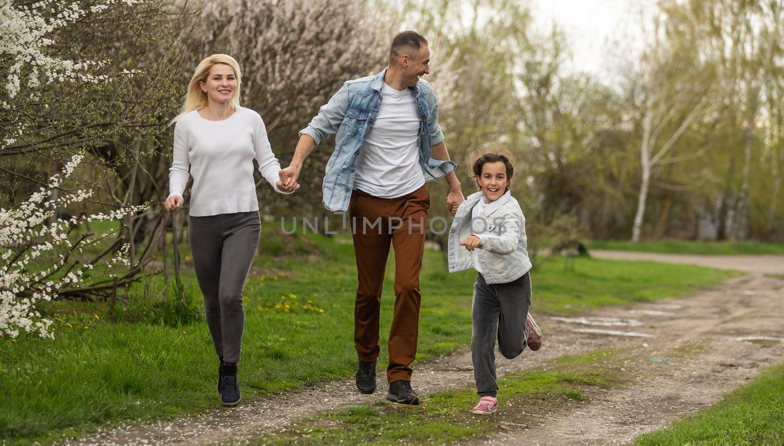 Young family with children and with dog having fun in nature by Andelov13