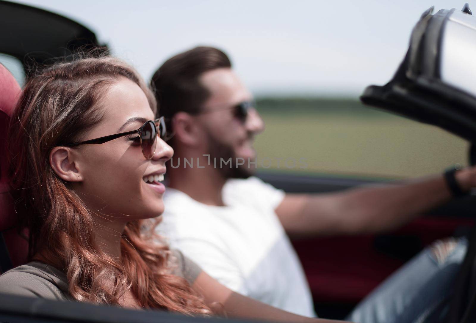 close up.a young woman with her boyfriend in a convertible car.the freedom of the open road