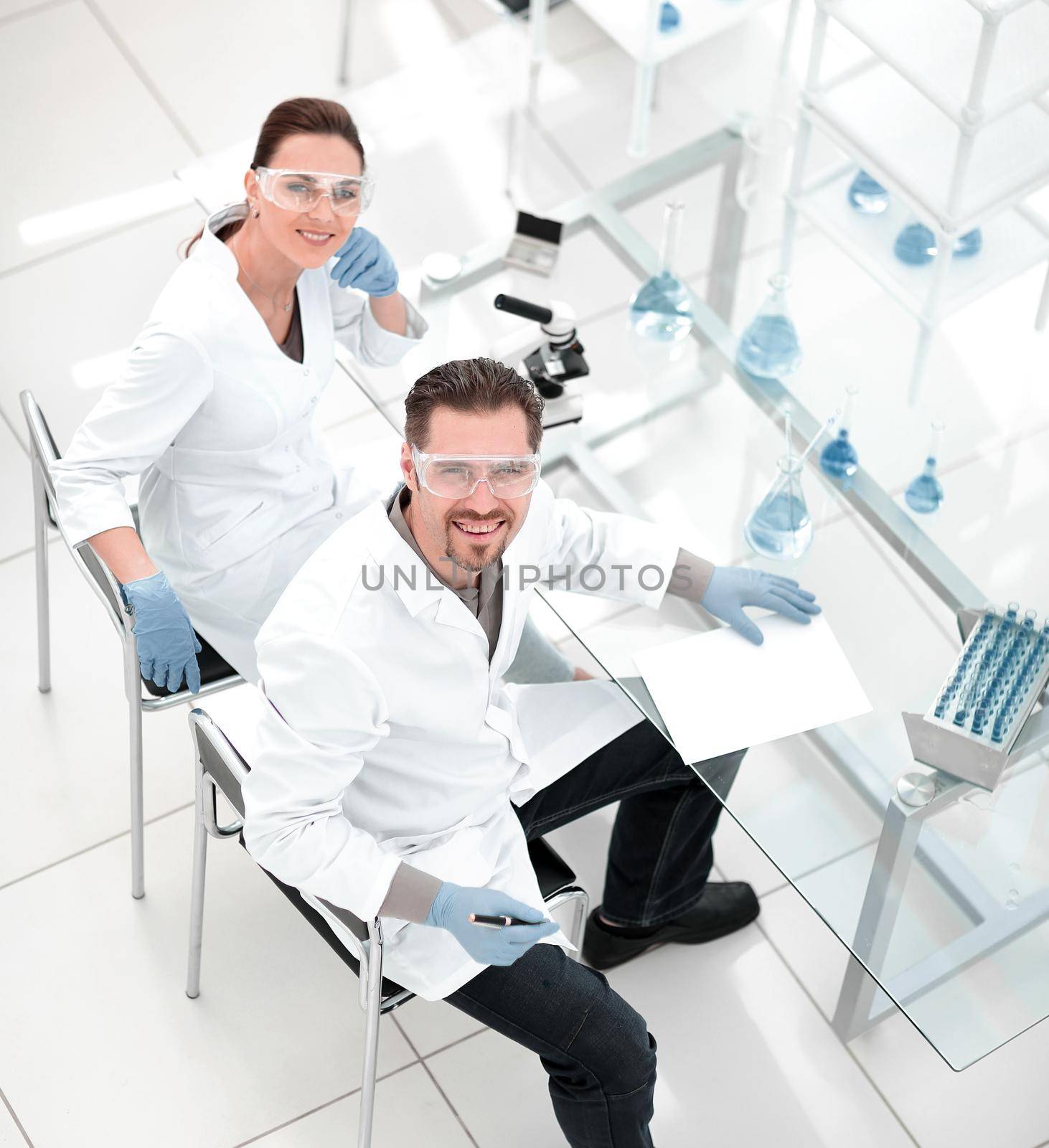top view.scientists at the laboratory table. by asdf