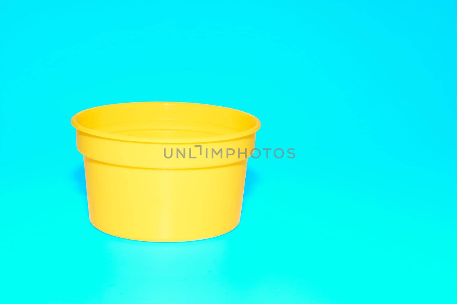 Yellow plastic jar capacity of isolated on blue azure by jovani68