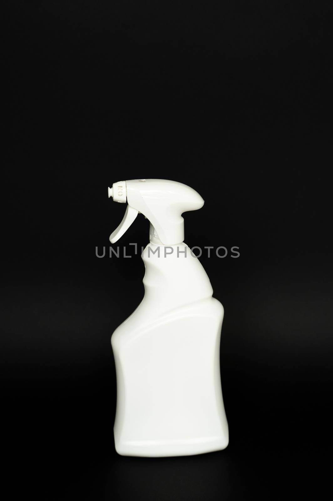 White plastic spray bottle for liquid cleaning products isolated on black background. Packaging mockup bottle with sprayer. by vovsht