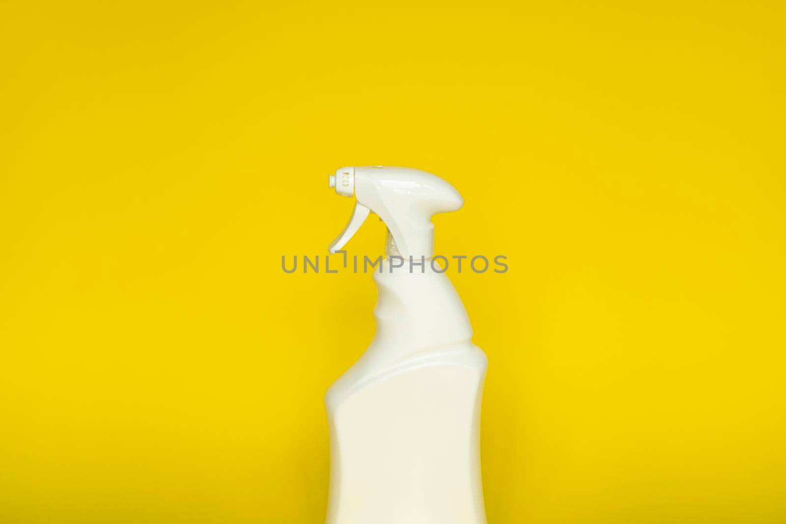 White plastic spray bottle for liquid cleaning products isolated on yellow background. Packaging mockup bottle with sprayer. by vovsht