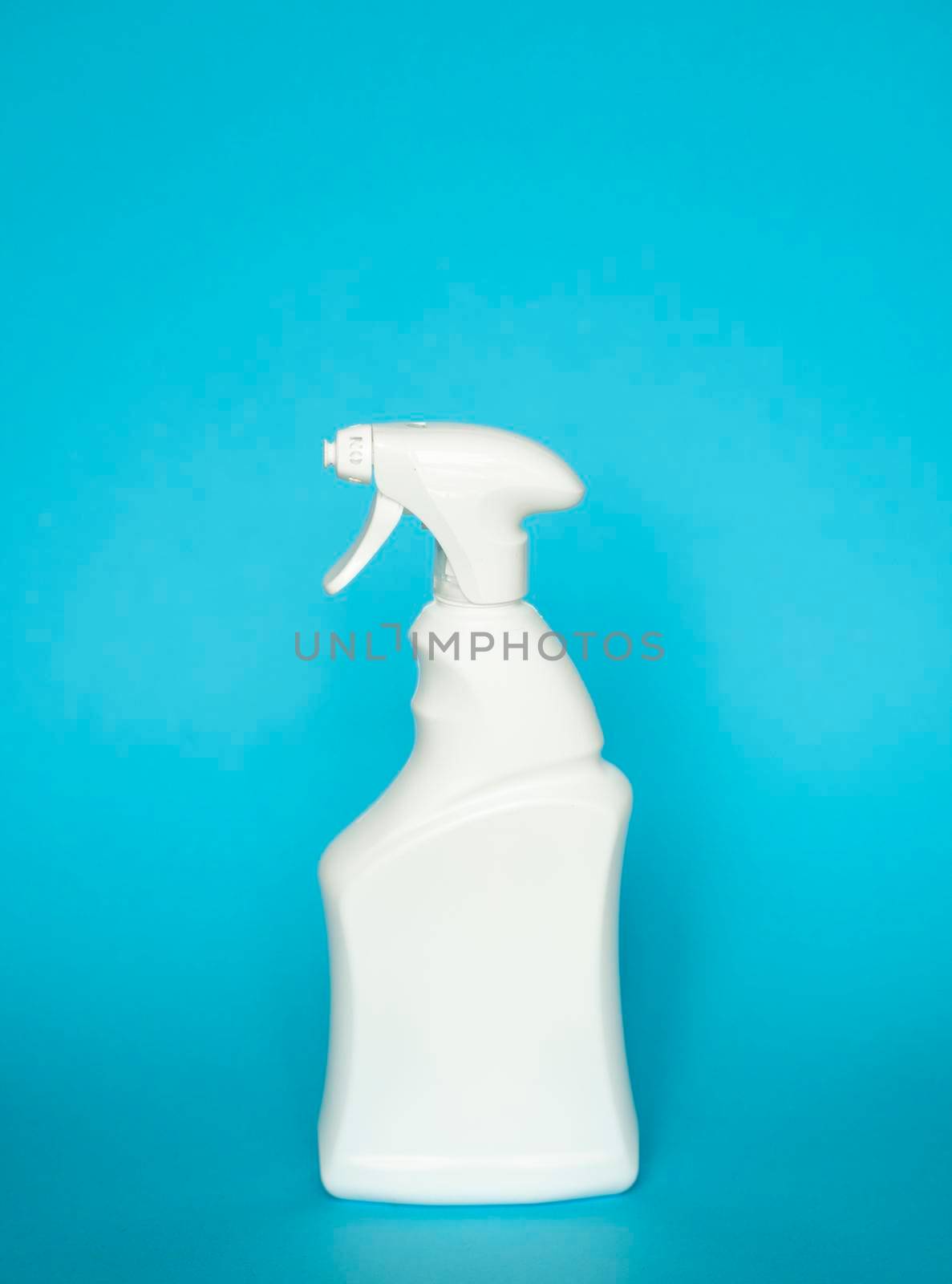 White plastic spray bottle for liquid cleaning products isolated on blue background. Packaging mockup bottle with sprayer