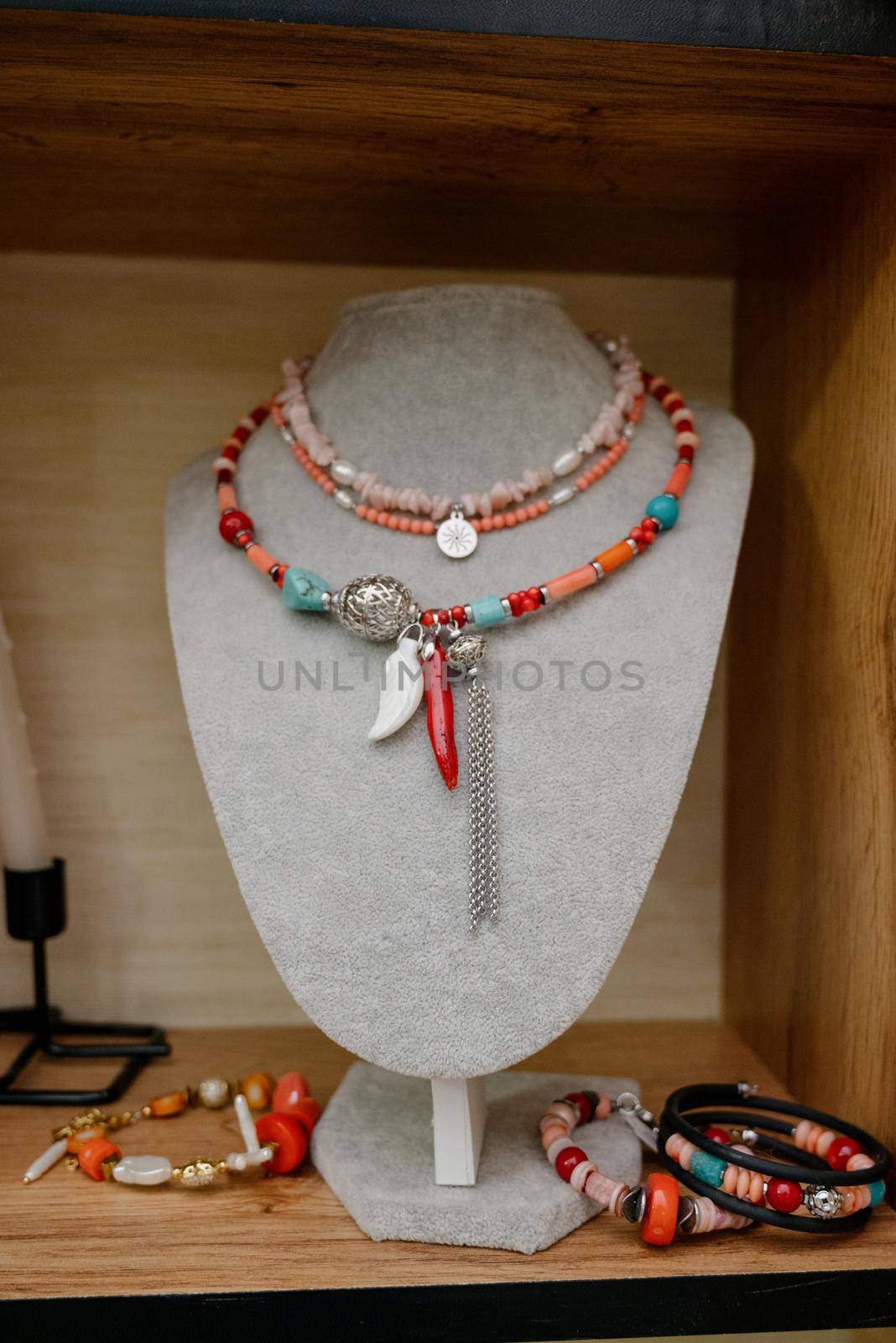 Shop window with necklaces and jewelry. Custome jewelry on display by Kovenkin