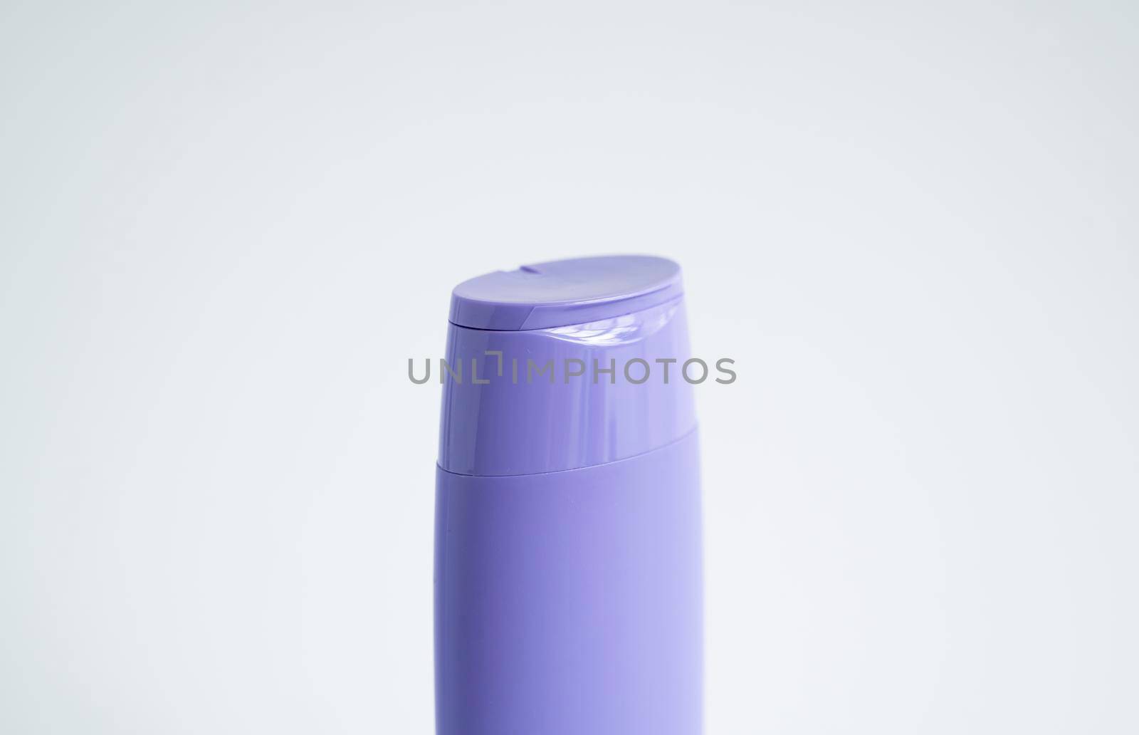 Violet plastic bottle of body care and beauty products. Studio photography of plastic bottle for shampoo, shower gel, creme isolated on white background. by vovsht