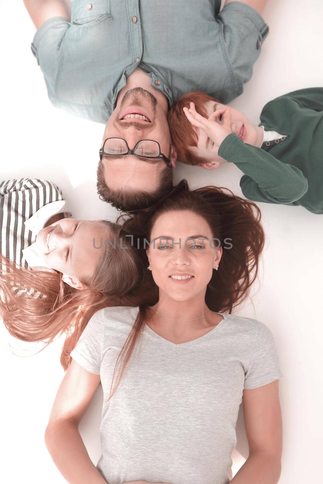 top view. happy parents with children to relax by lying on the floor by asdf