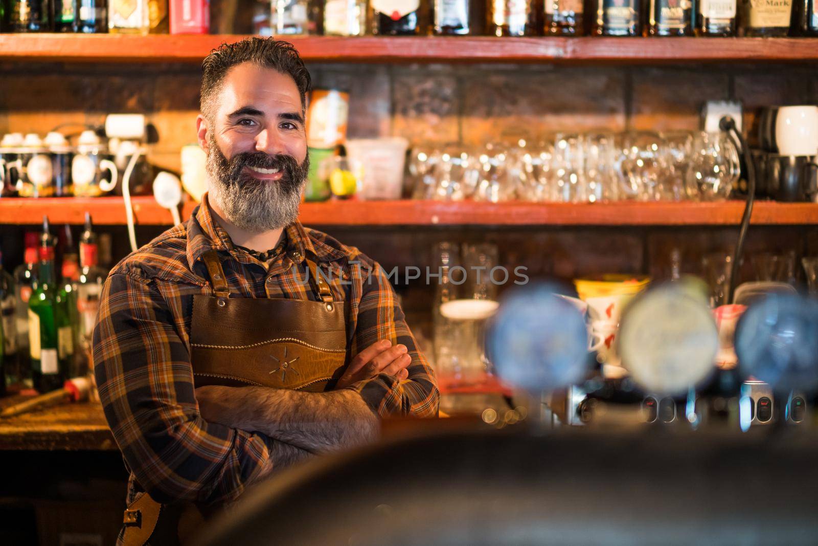 Portrait of barmen at pub. Adult man working as barmen.