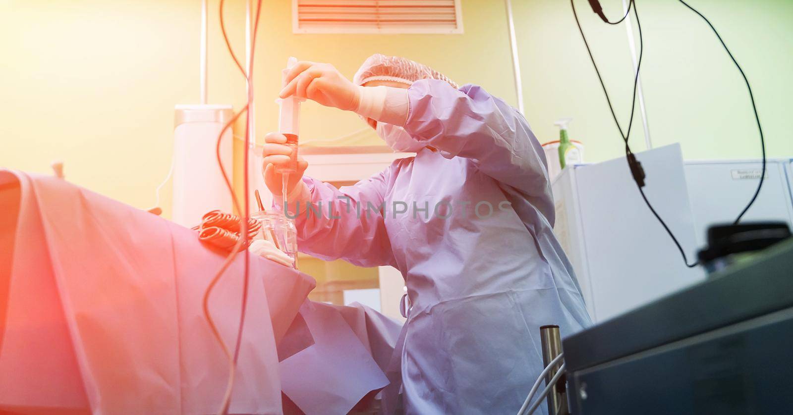 The Ross operation is the surgical treatment of aortic valve defects. The nurse draws medicine into a syringe.