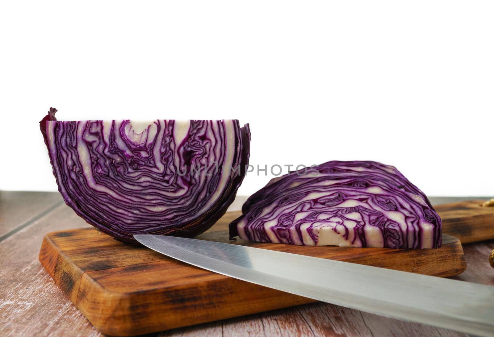 red cabbage or red cabbage with knife on wooden board by joseantona