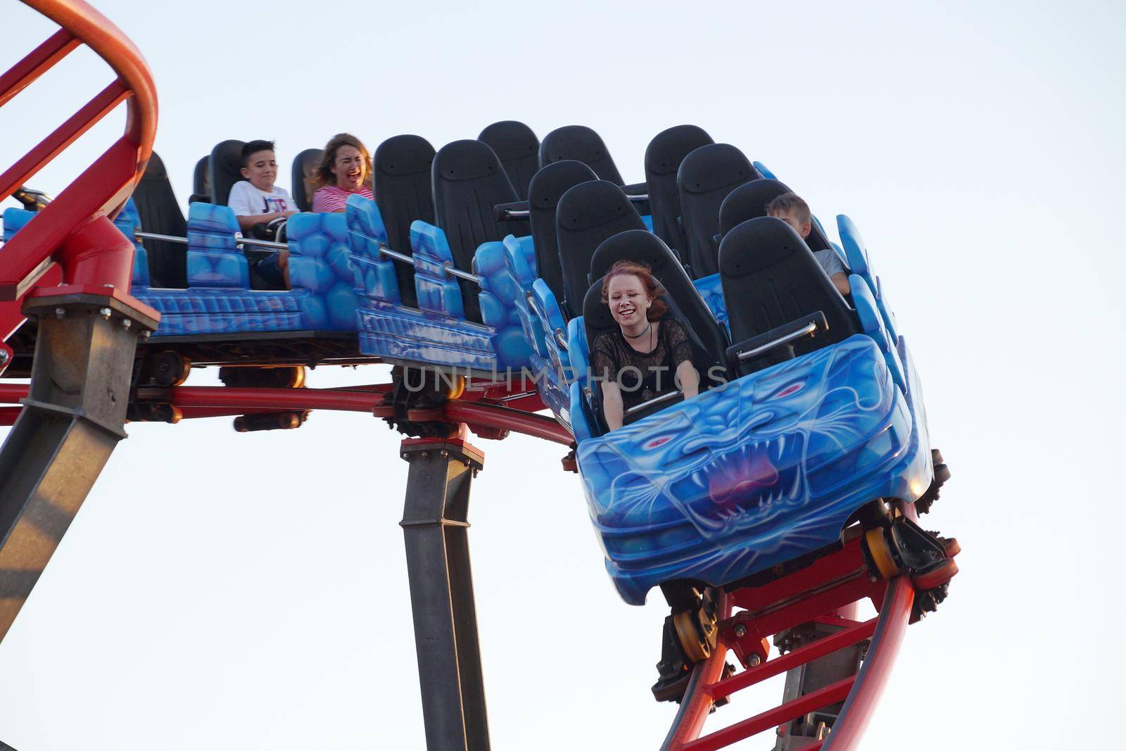 Varna, Bulgaria - July, 23, 2022: people emotionally ride a high-speed roller coaster