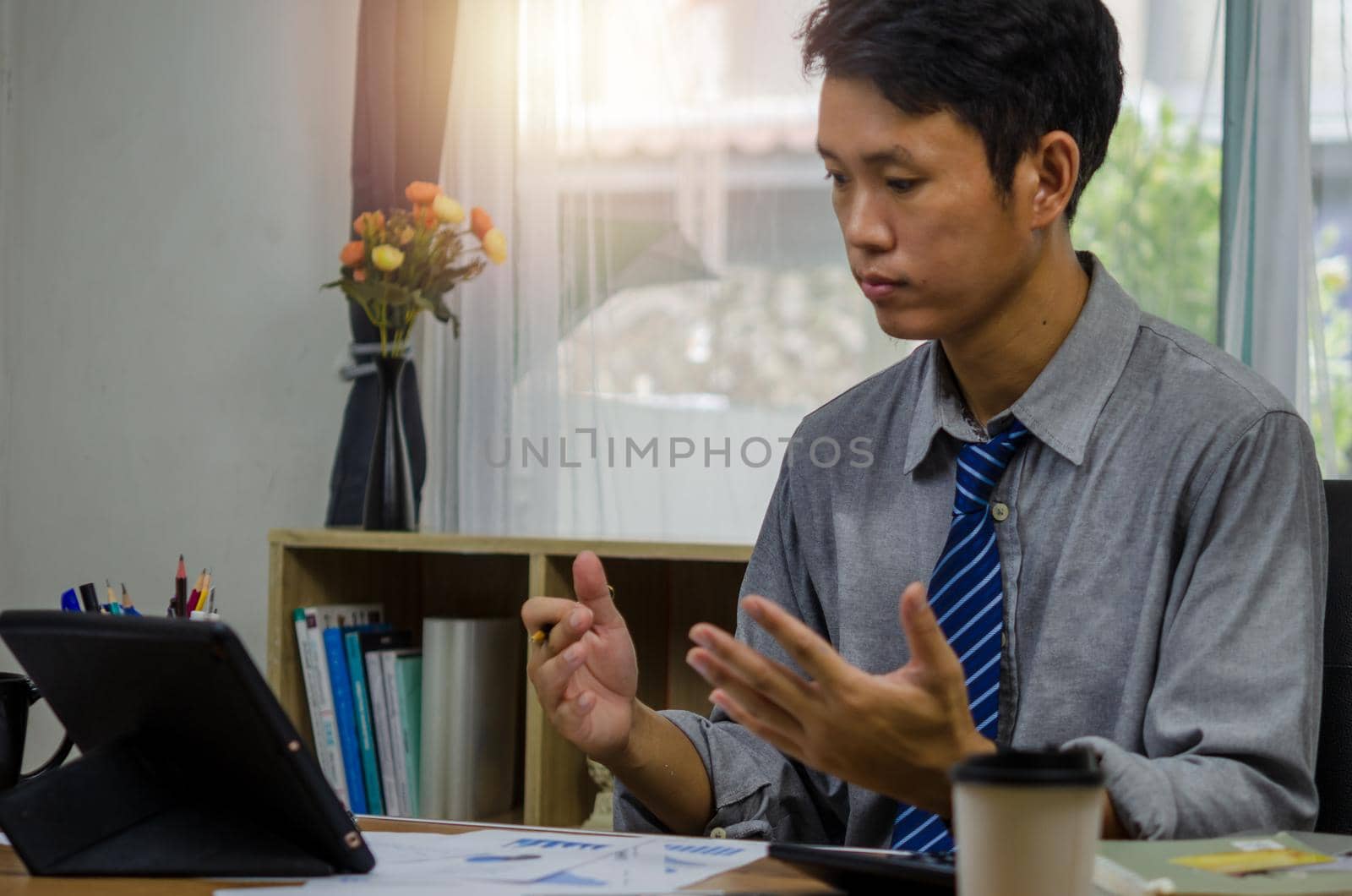 businessman looks at document financial and economic investment chart and graph paperwork marketing is sitting at laptop computer. by aoo3771