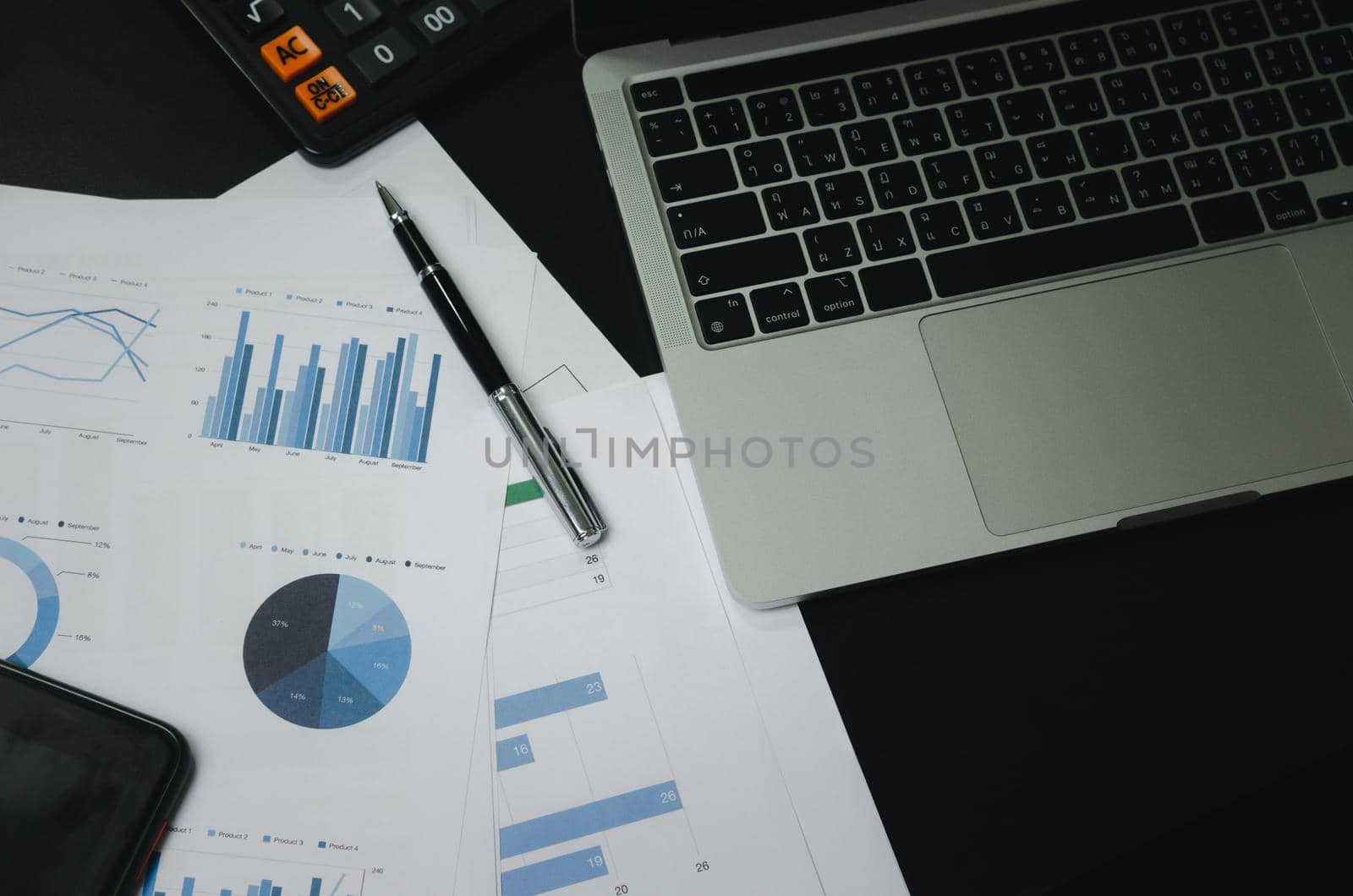 Business document finance graph and chart report analysis marketing and accounting with computer laptop on desk at office.
