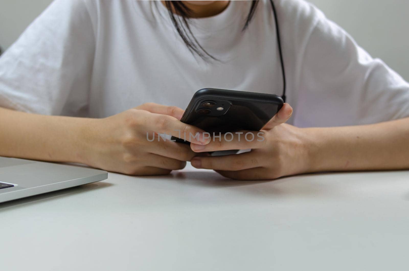 Young girl hand holding mobile smartphone communication and digital internet social network technology on table. by aoo3771