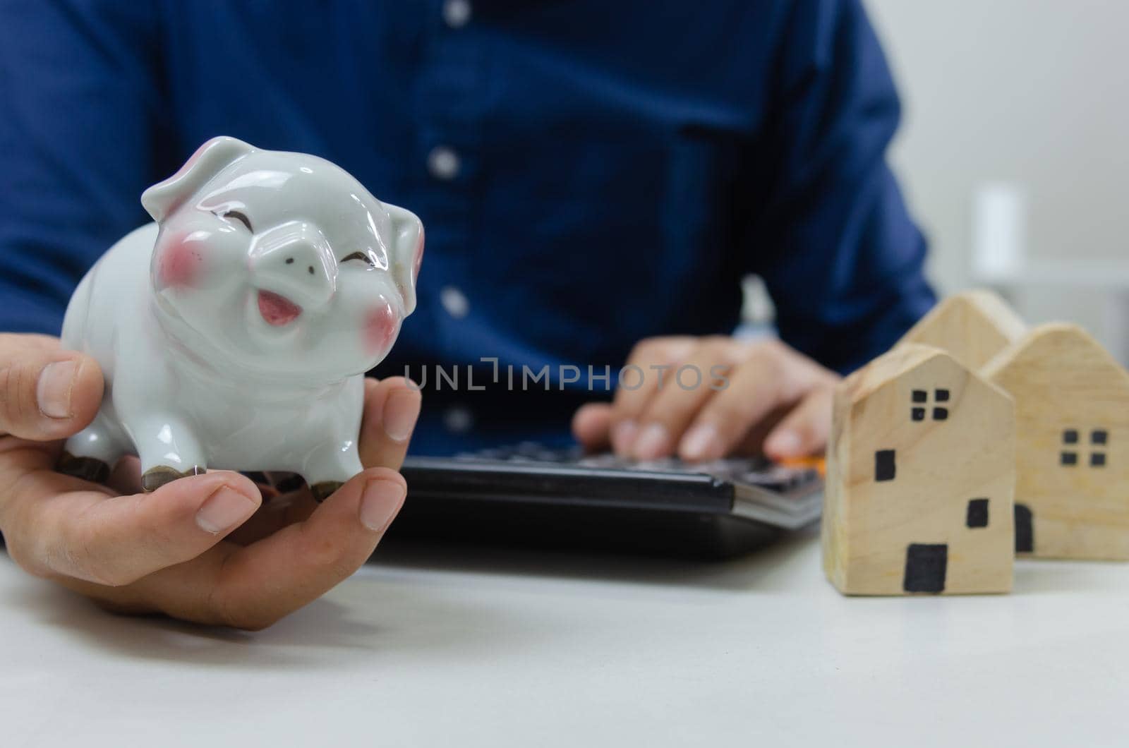 Saving a piggy bank for real estate and housing purchases. Business finance investments taxes or retirement money and concept insurance.