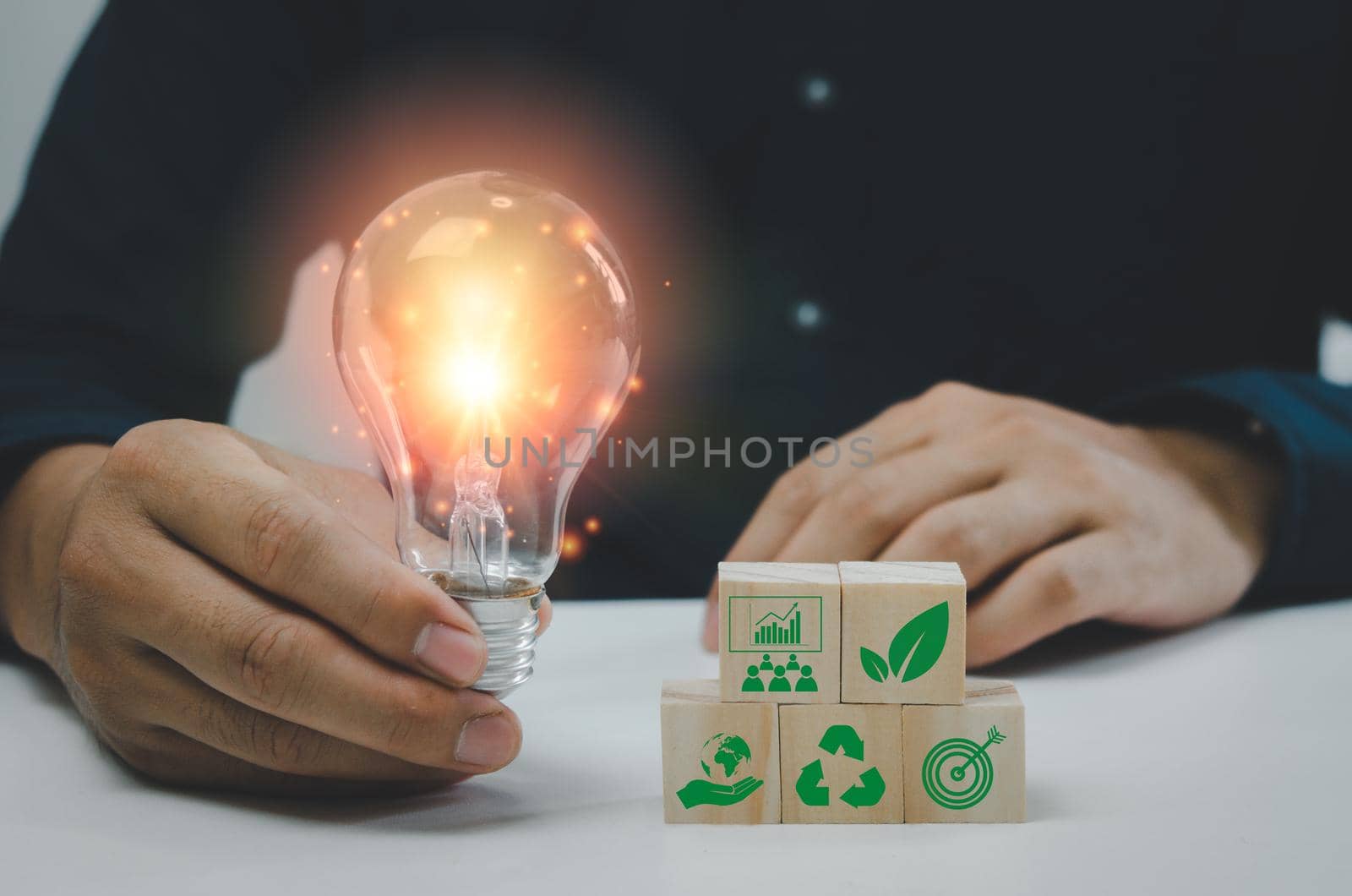 Hand man holding bulb light and wood cube green eco environmental and net zero concept. by aoo3771