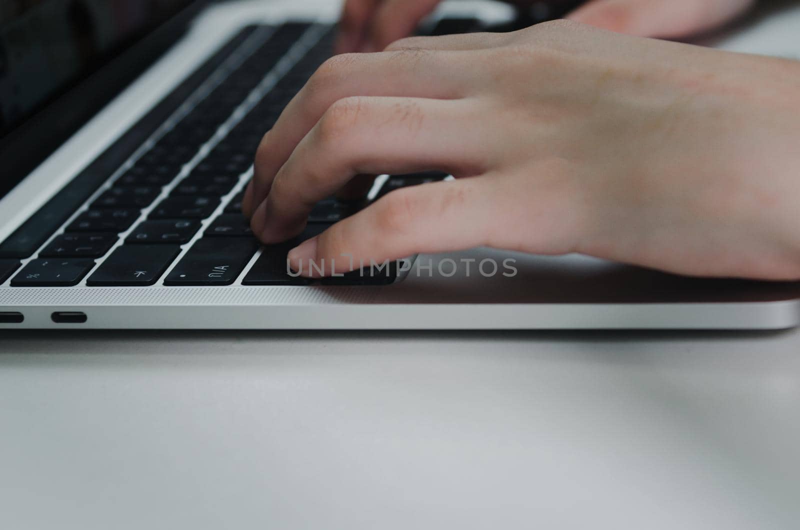 close up hand woman typing keyboard computer laptop on desk.Business technology online and communication on desk. by aoo3771