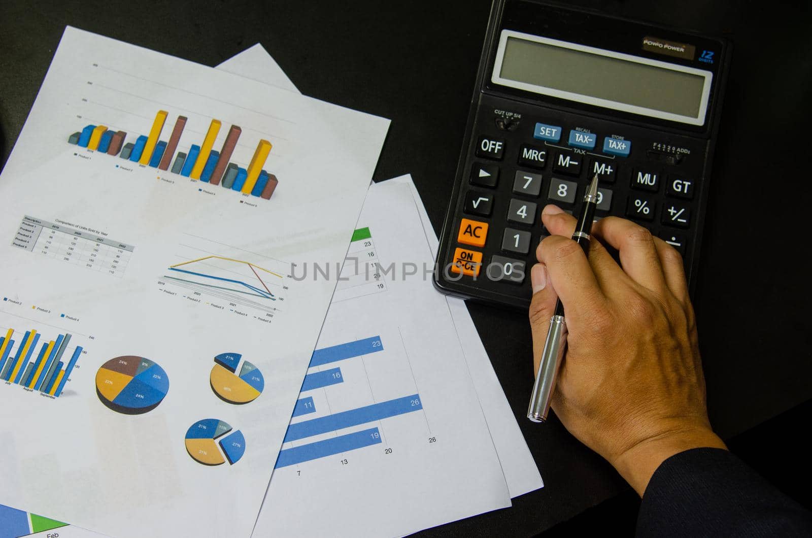 Top view document chart analysis diagram plan financial and graph report information economic and tax with pen and calculator on black desk. by aoo3771