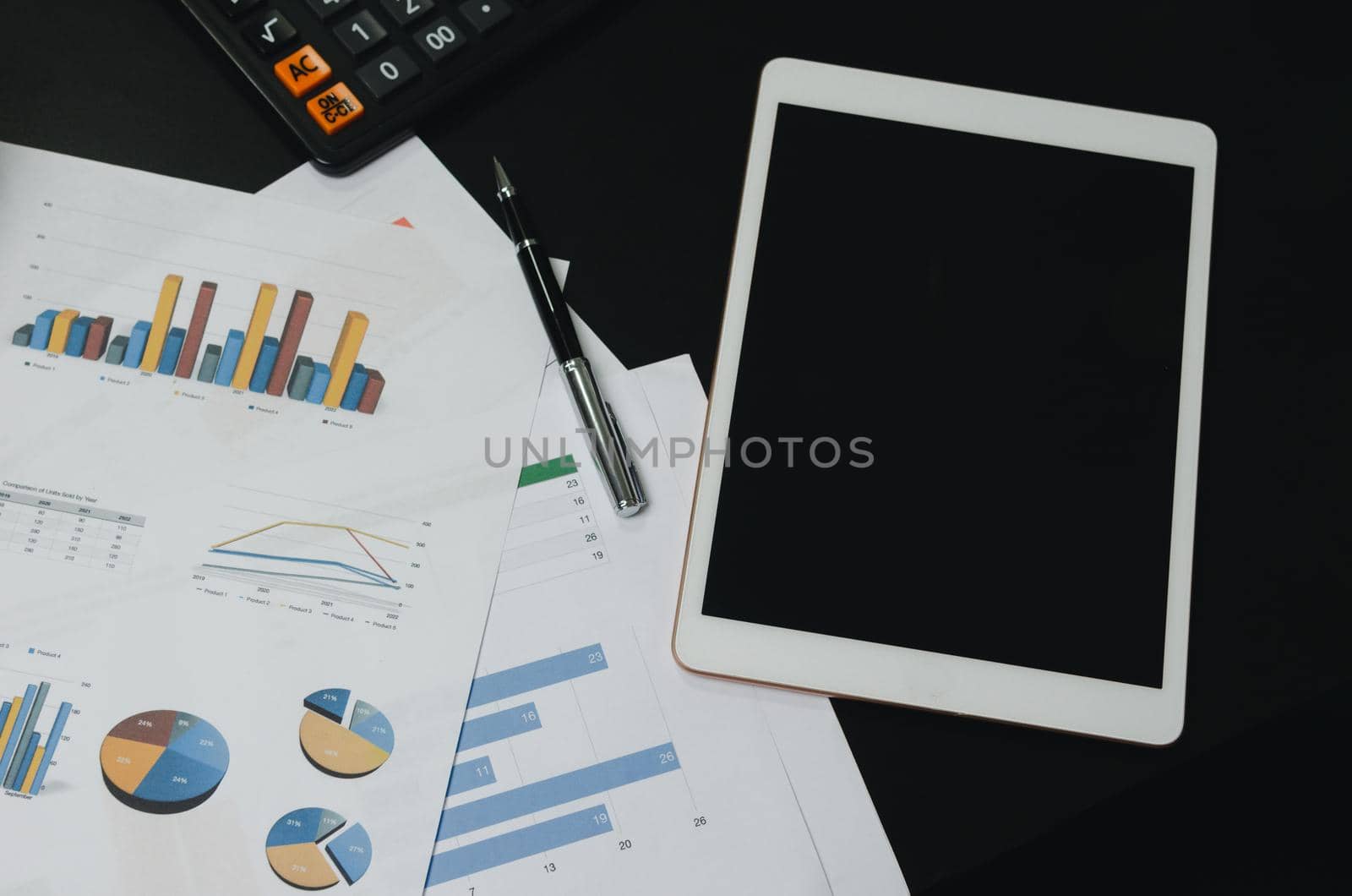 Top view document chart analysis diagram plan financial and graph report information economic and tax with pen and tablet on black desk. by aoo3771