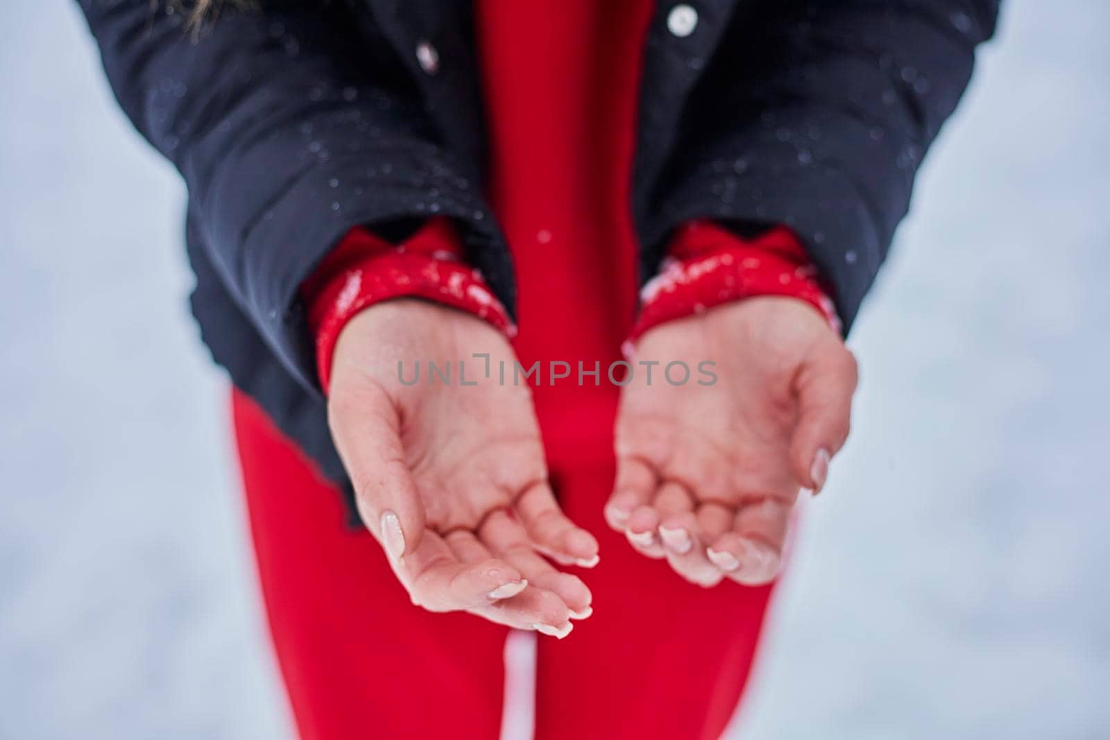 hands of a young woman, close-up, frozen from playing snowballs. by mosfet_ua