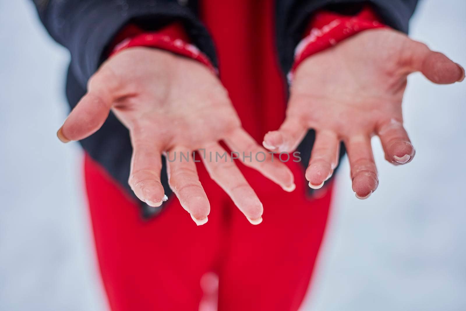 hands of a young woman, close-up, frozen from playing snowballs