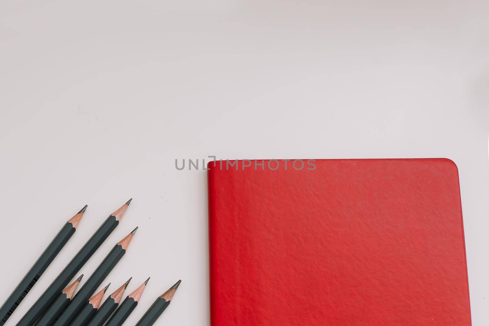 Back to school concept, school and office supplies, top view of notebook and pencils on white background, flat lay, copy space