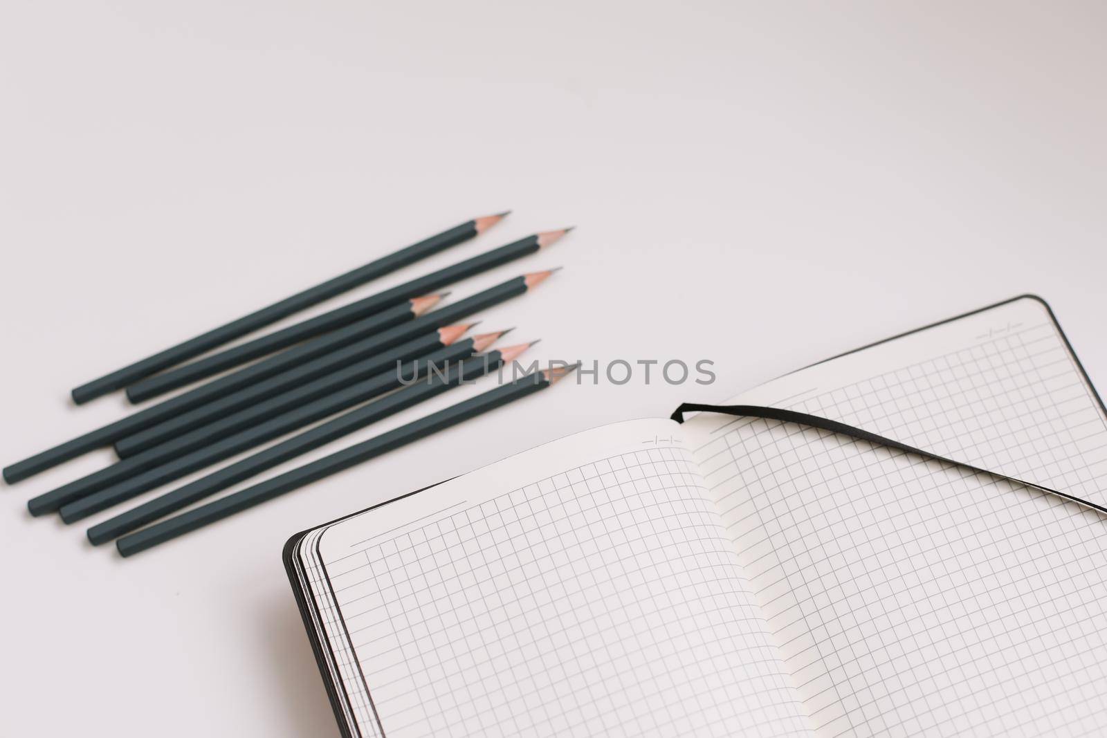 Back to school concept, school and office supplies, top view of notebook and pencils on white background, flat lay, copy space