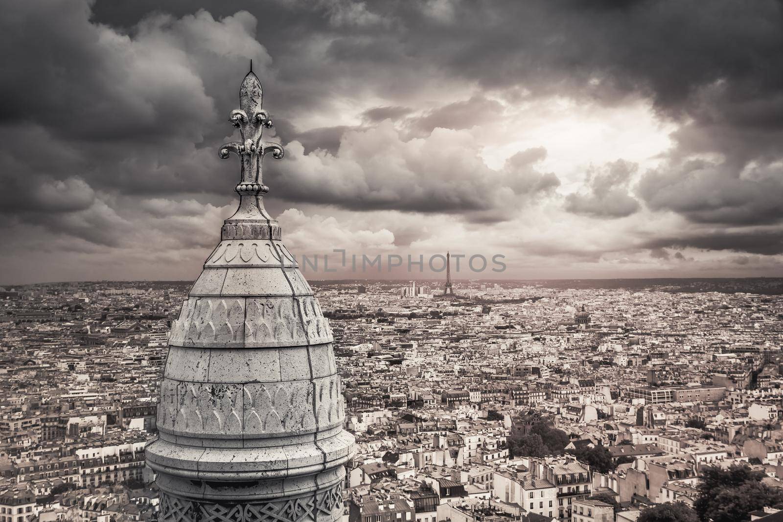 Panoramic view above Paris from Sacre Couer in Montmartre with dramatic storm clouds sky, France