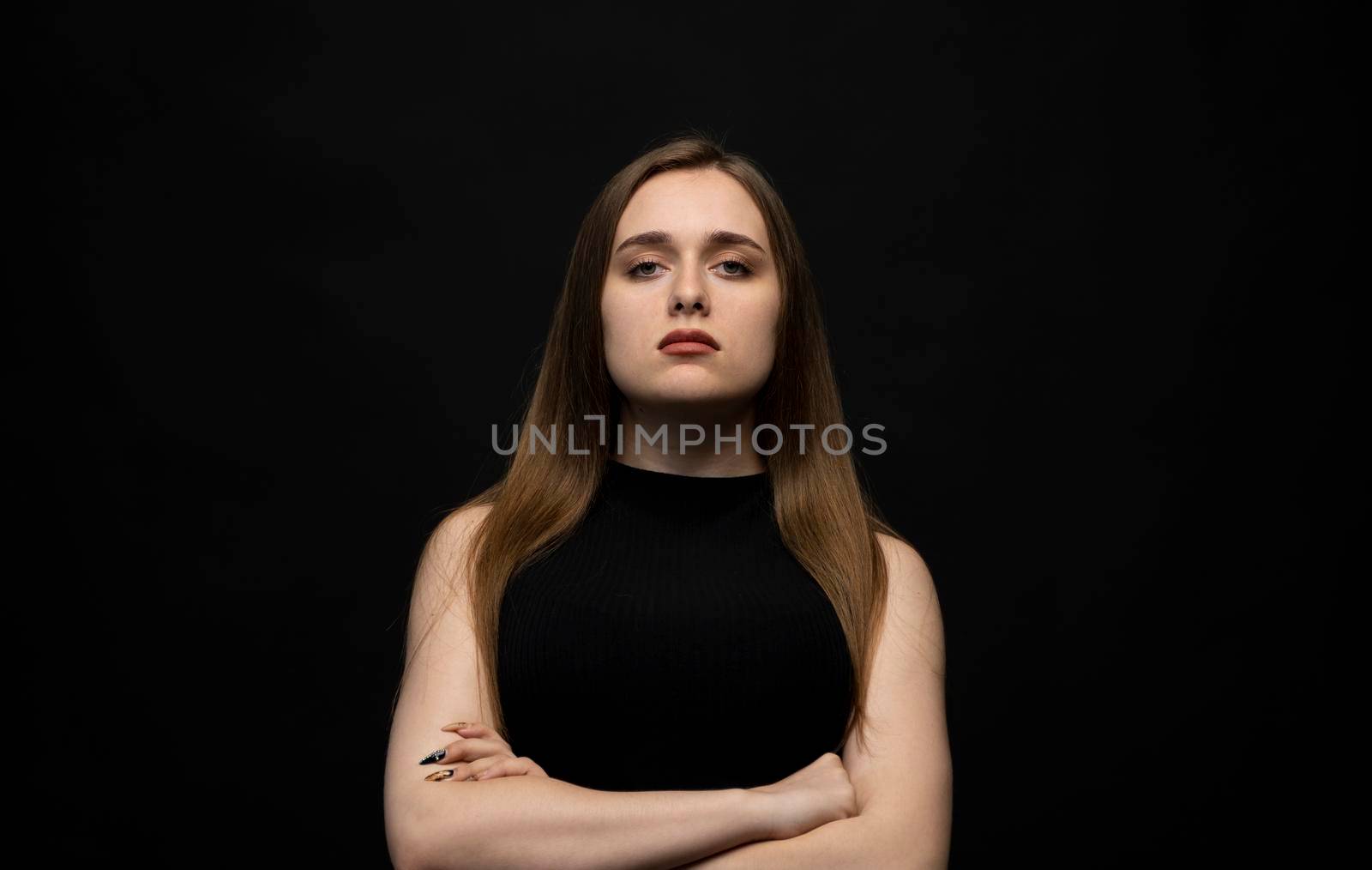 Grumpy woman with long hair expressing negative emotions. Furious woman showing her disgust while having quarrel