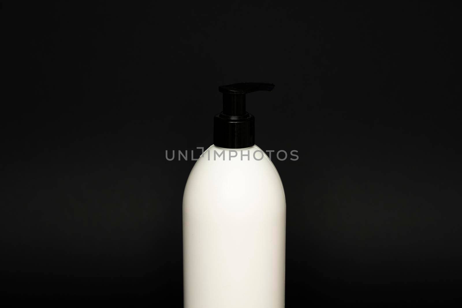 Liquid container for gel, lotion, cream, shampoo, bath foam. Cosmetic plastic bottle with dispenser pump on black background. Cosmetic packaging mockup with copy space. by vovsht