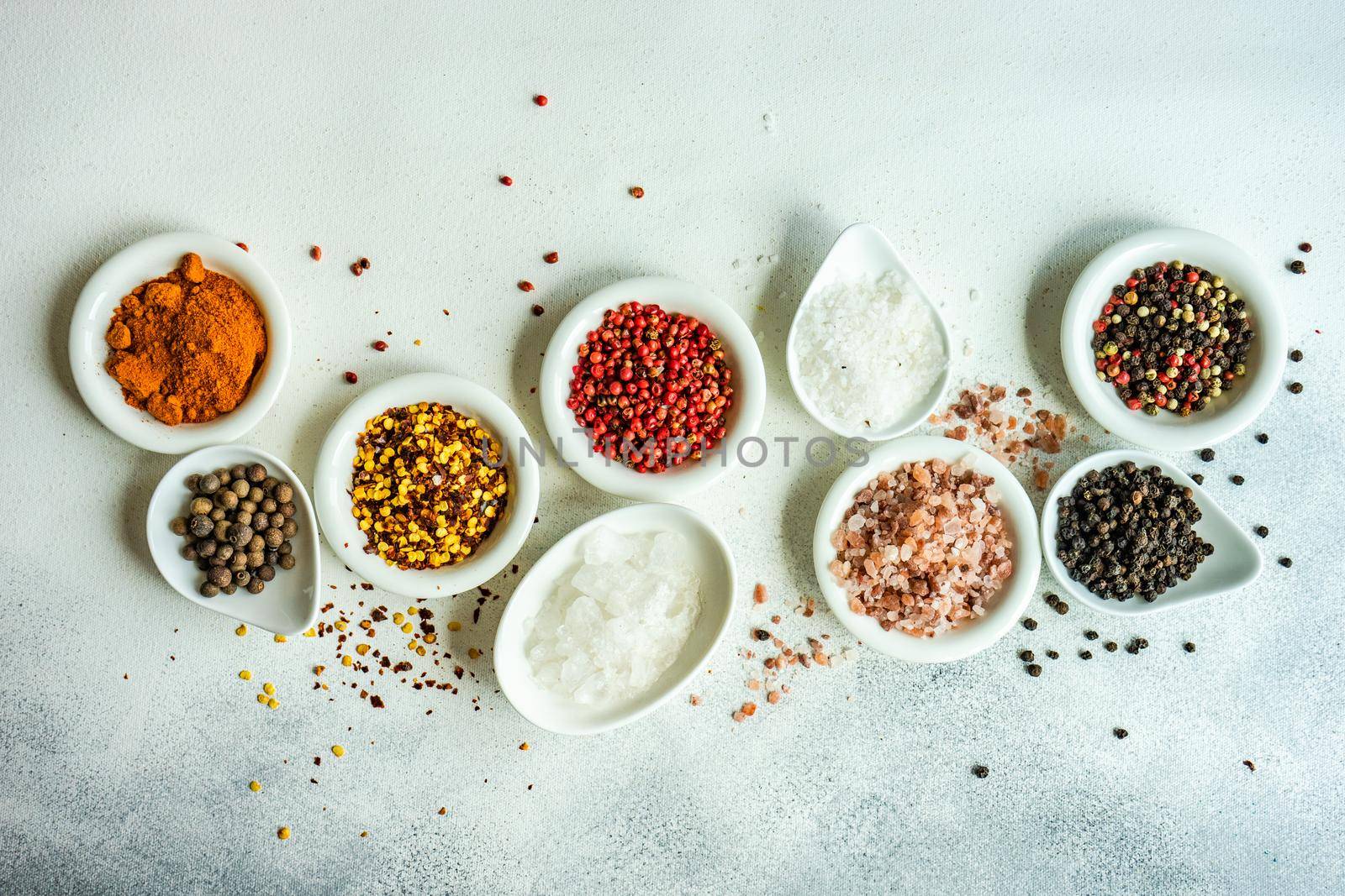 Spices in the bowls as a cooking frame on concrete table