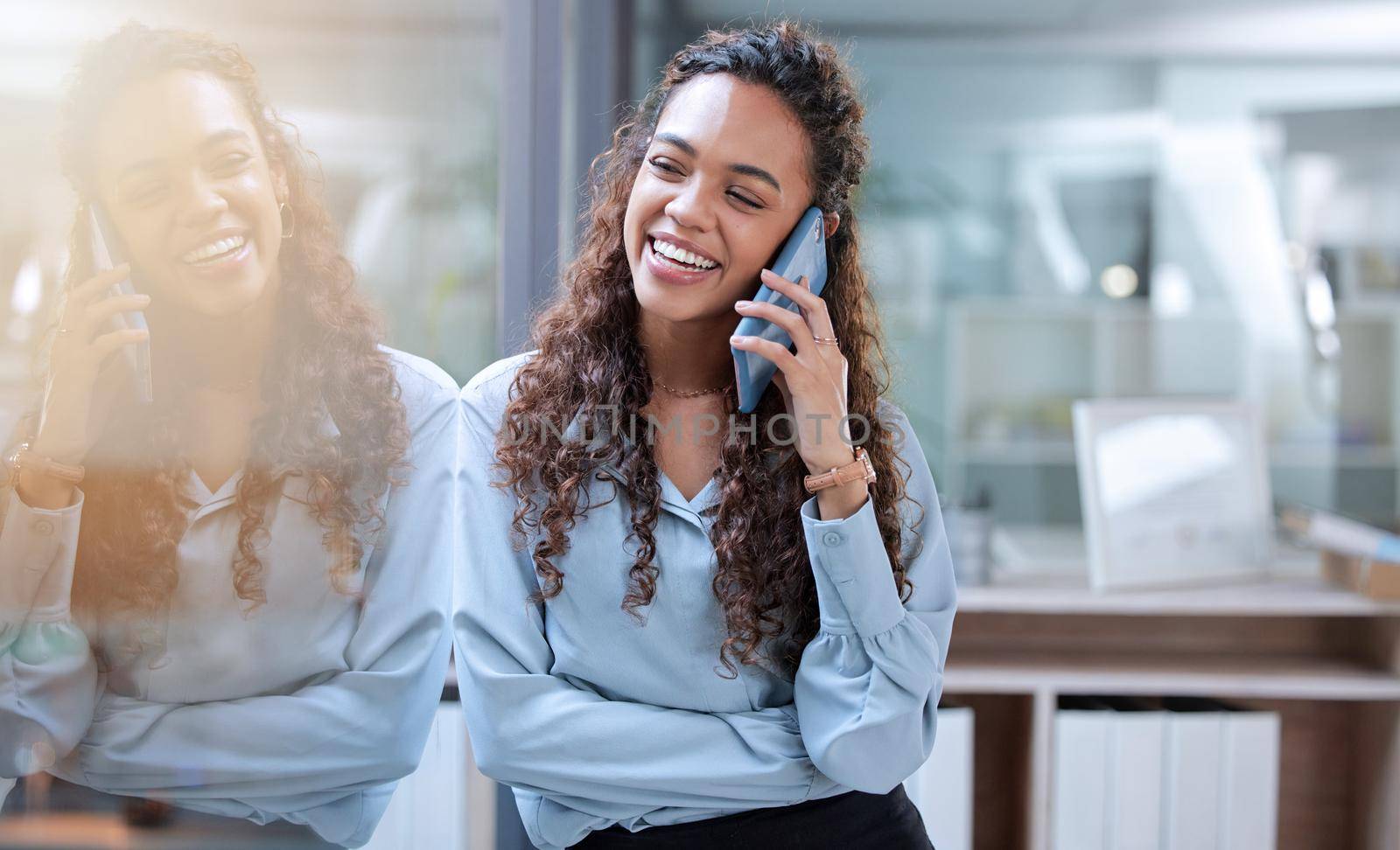 Communication makes everything easier. an attractive young businesswoman making a phonecall while standing in her office
