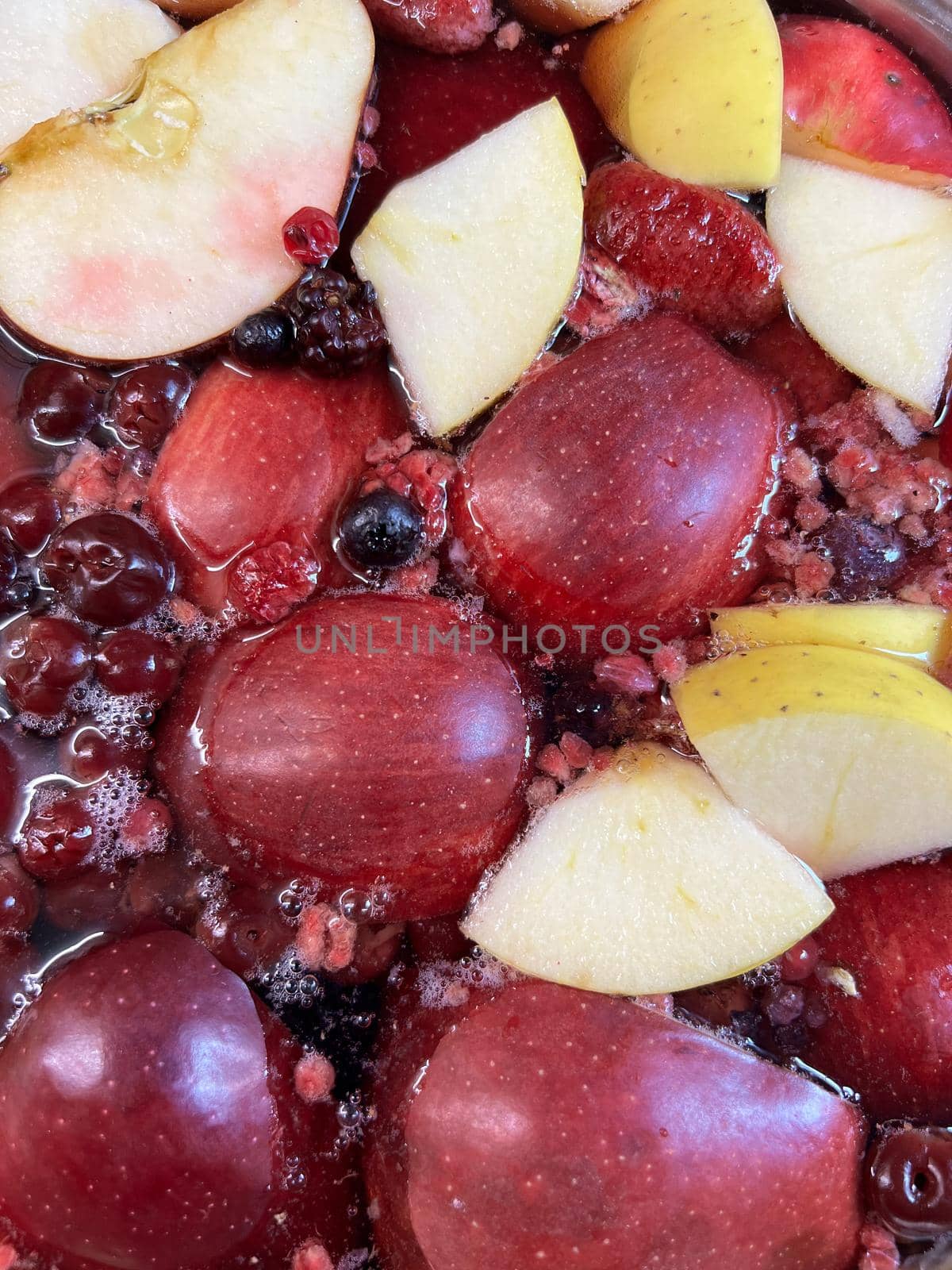 Compote of pomegranates, apples and cherries. Close-up. High quality photo
