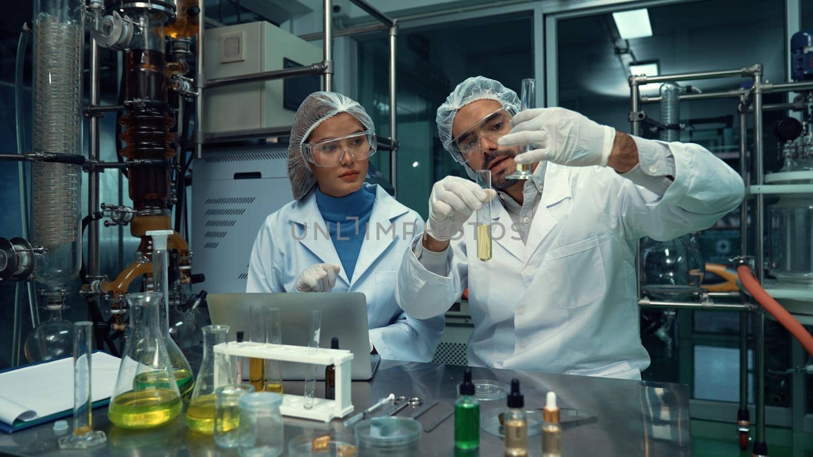 Two scientist in professional uniform working in laboratory for chemical and biomedical experiment