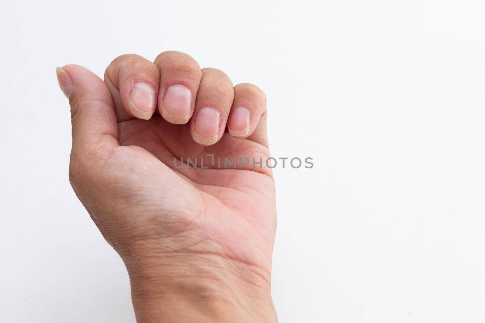 Cropped caucasian woman hand showing healthy cared nails without polish on white background