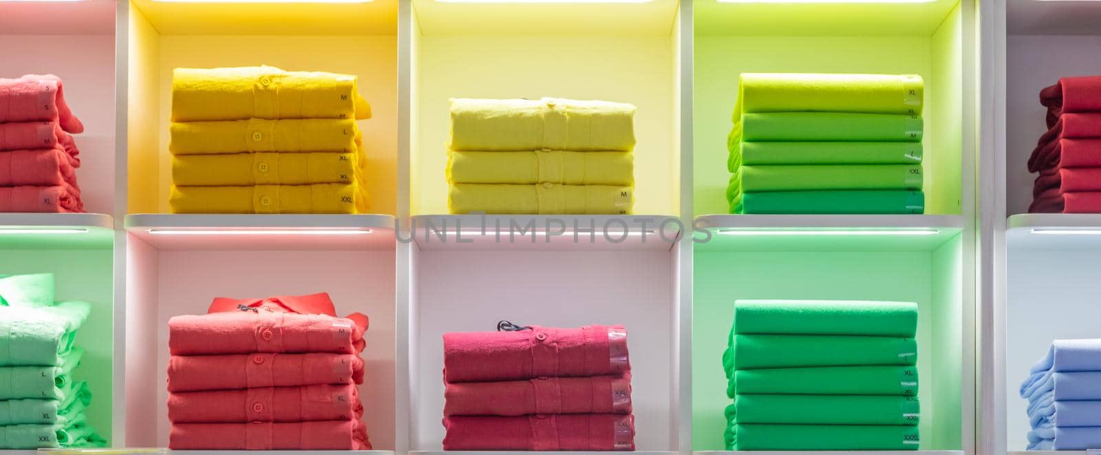 Polo t-shirt store interior. Shop shelves with  colored fashion cotton shirt by Perseomedusa
