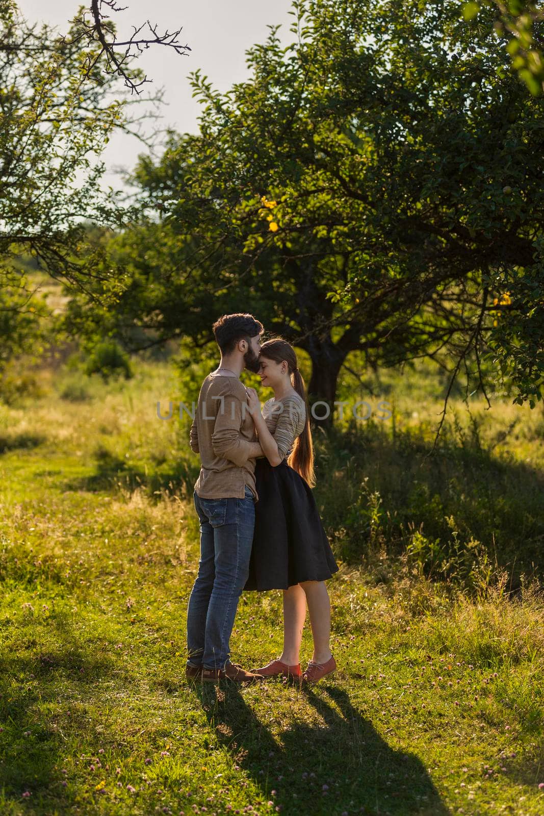 young couple hugging on nature background