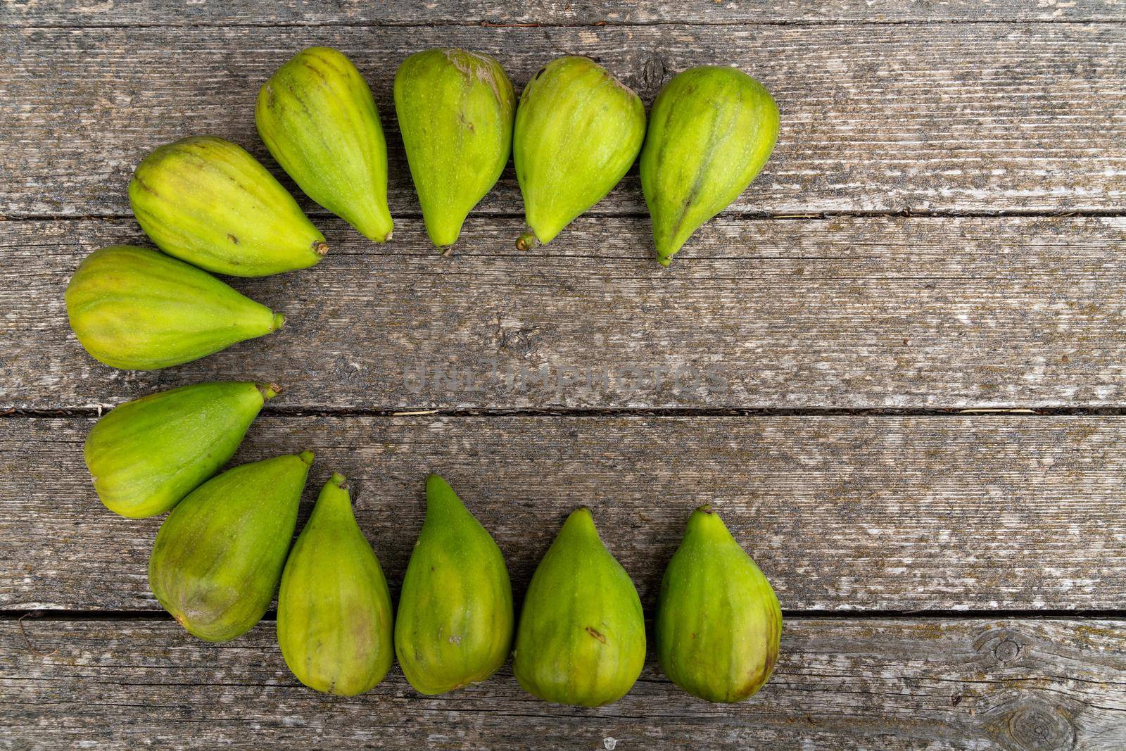 Fresh figs. Ripe figs on a wooden background. Bulk figs close-up by Matiunina